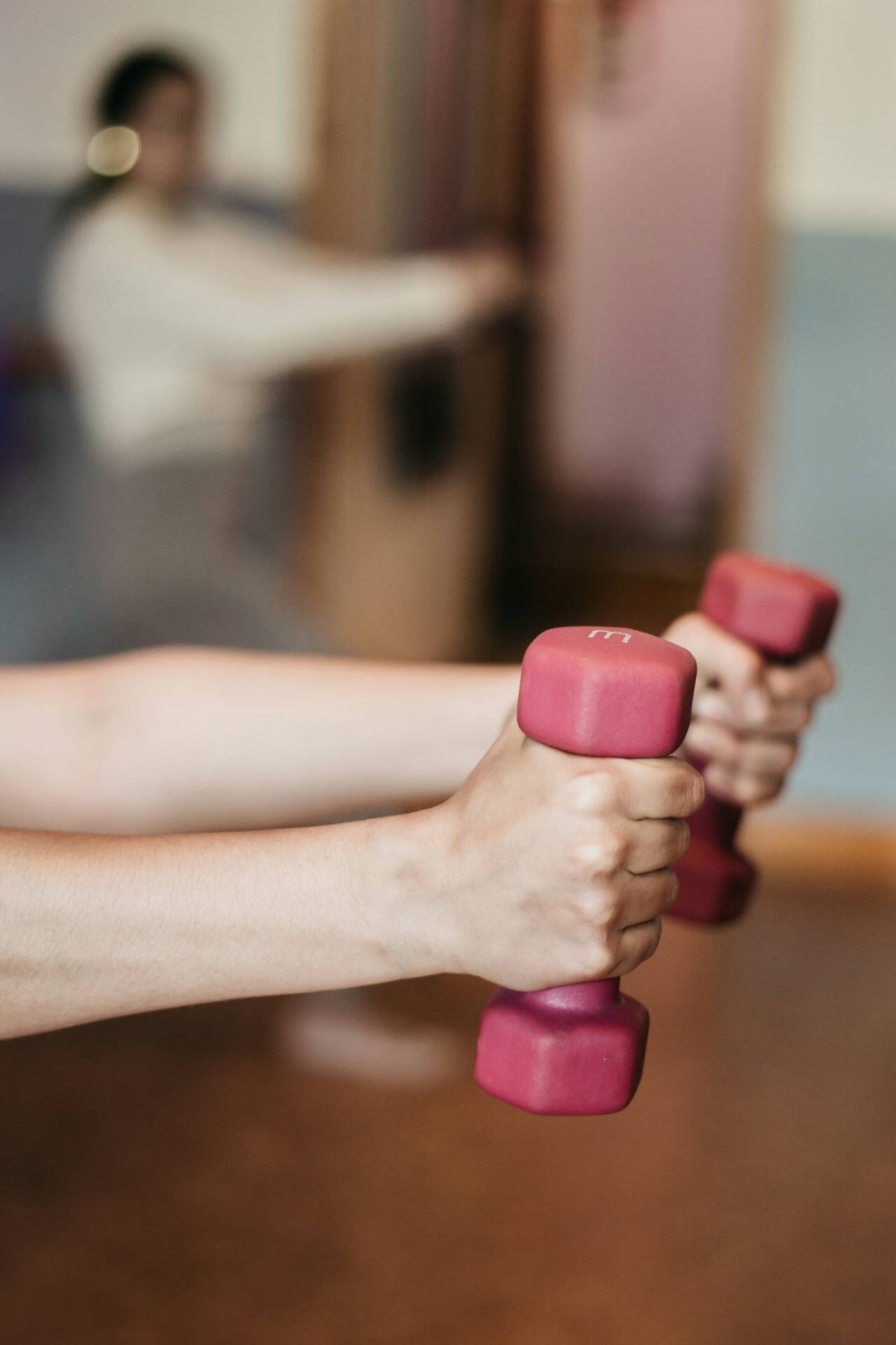 Hand gripping a light dumbbell during exercise