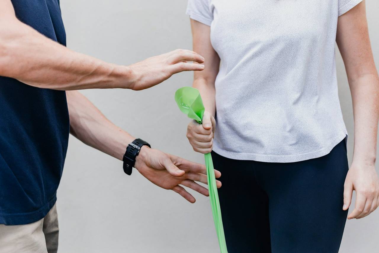 Student practising resisted exercise with a patient