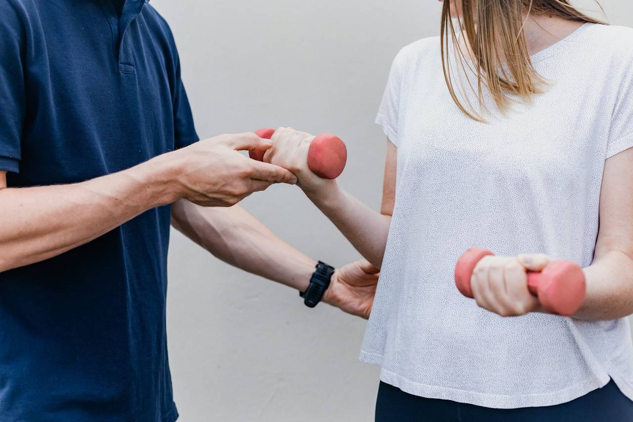 Physiotherapist guiding a patient through strengthening exercise